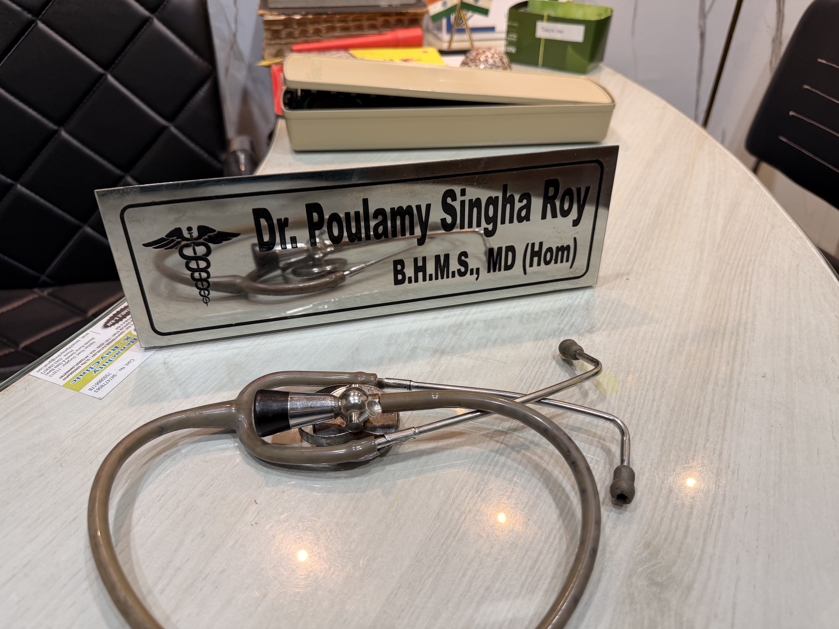Clinic desk with Dr. Poulamy Singha Roy name plate